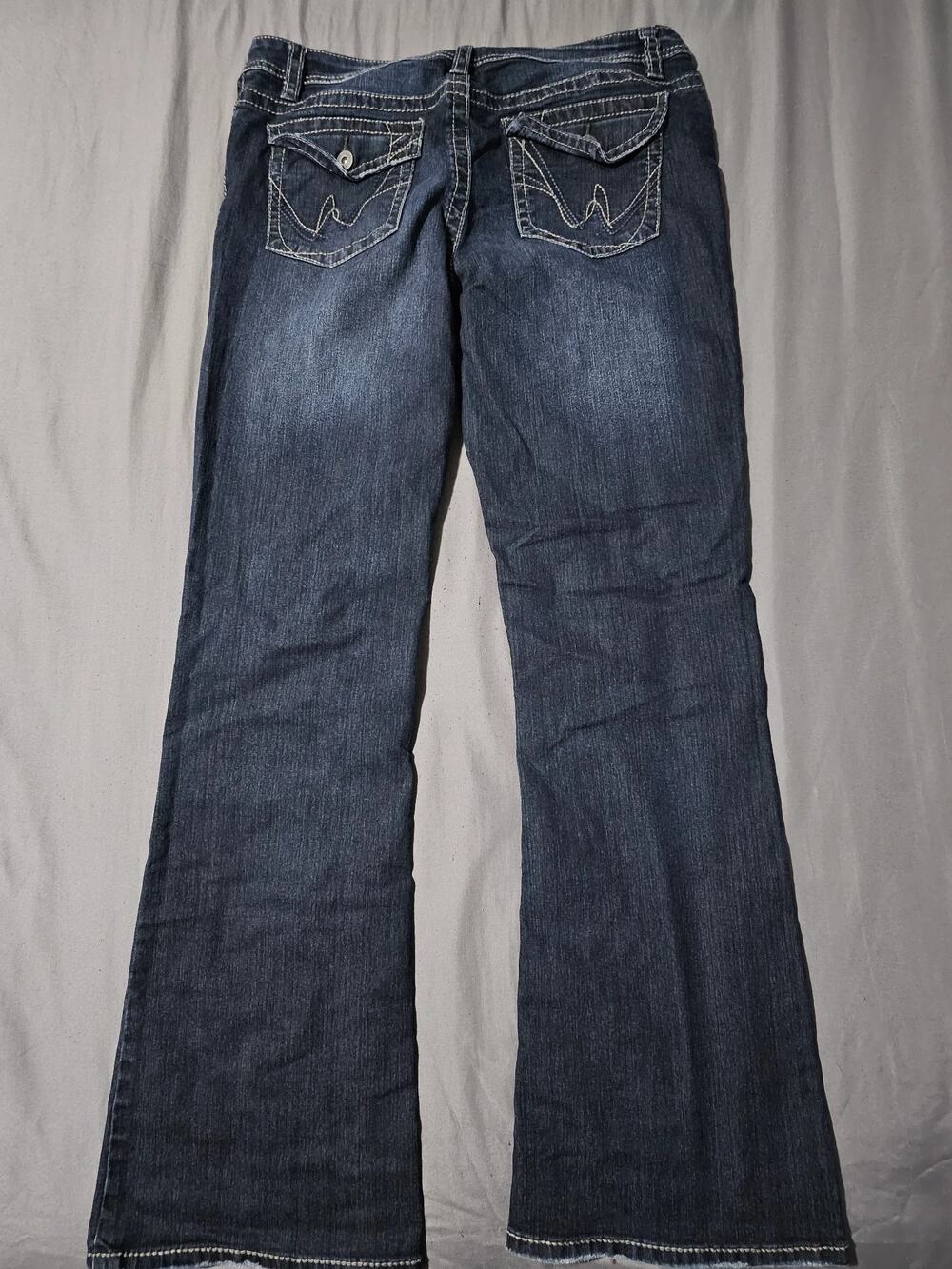 Dark wash bootcut jeans with flap back pockets and contrast stitching